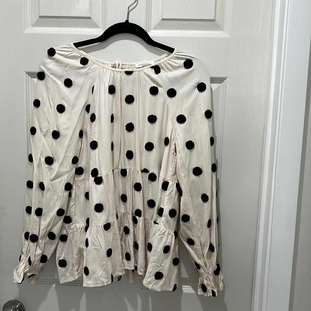 Crams and black polka dot long sleeve shirt.